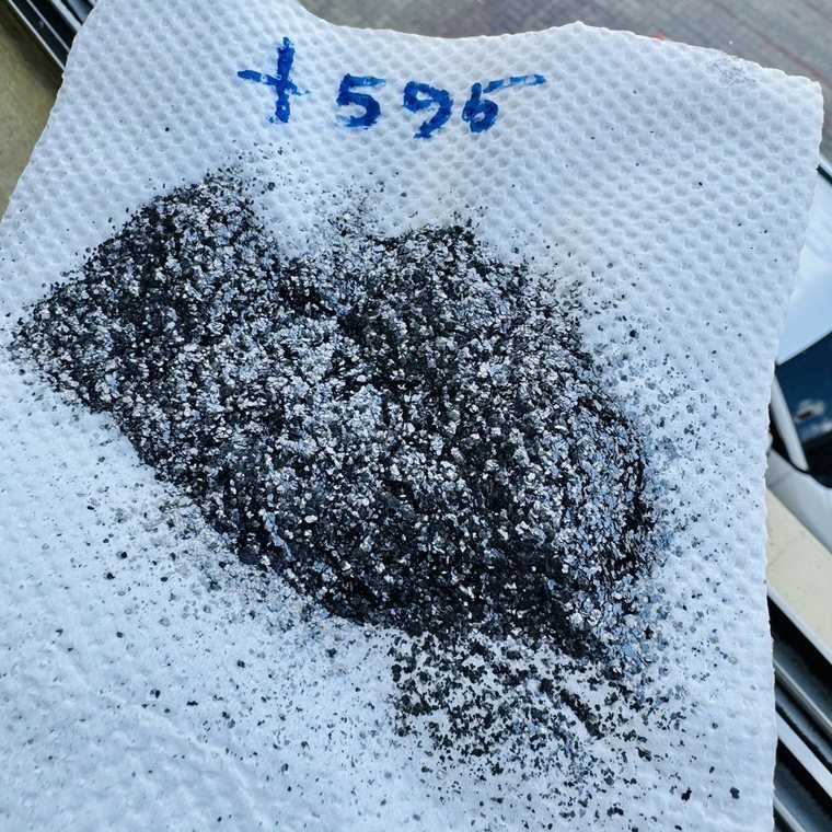 Flake graphite sample photographed on site, +50 mesh, 96 percent fixed carbon